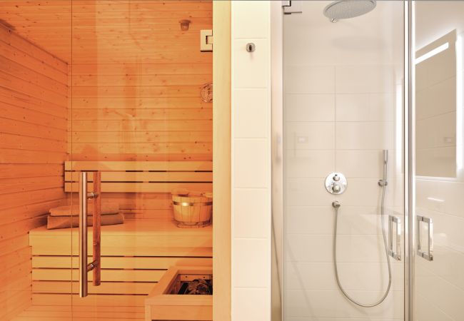 Bathroom with sauna and rain shower in the holiday home flat Alm Lodge A5 in Tauplitz