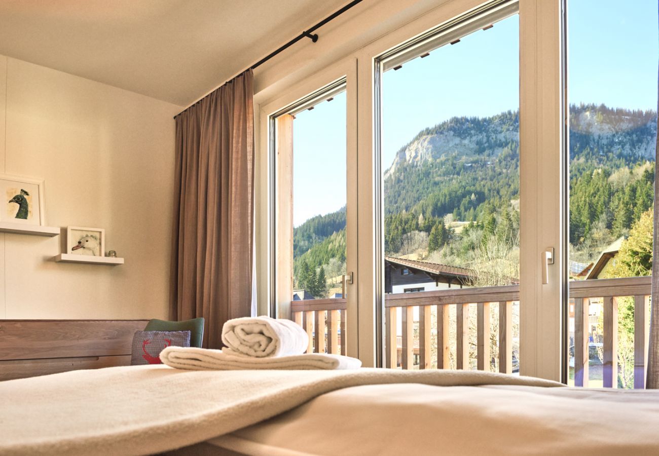 Bedroom 1 with a view over the mountains in the holiday home flat Alm Lodge A5 in Tauplitz