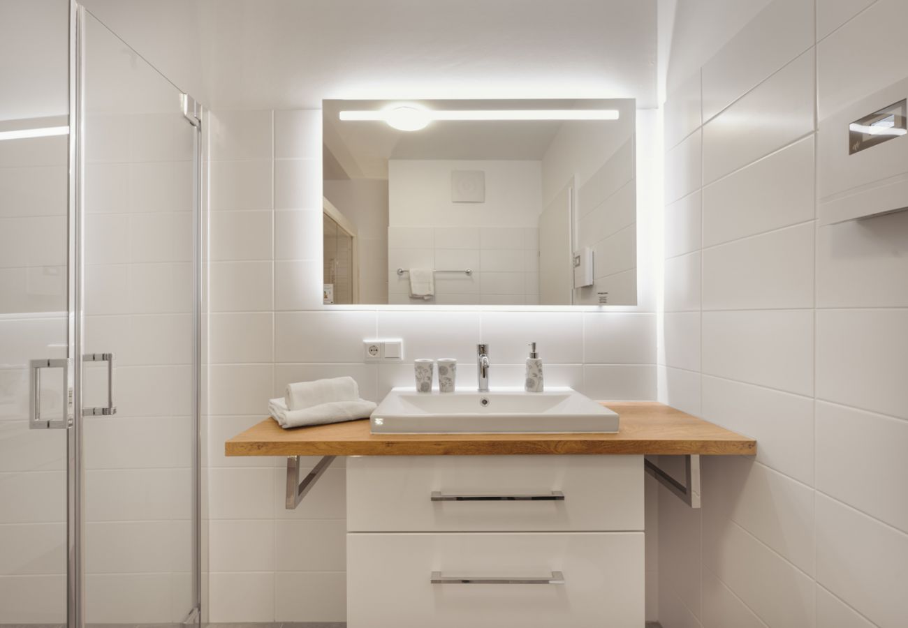 Bathroom with bathroom cabinet and washbasin in the holiday home flat Alm Lodge A5 in Tauplitz