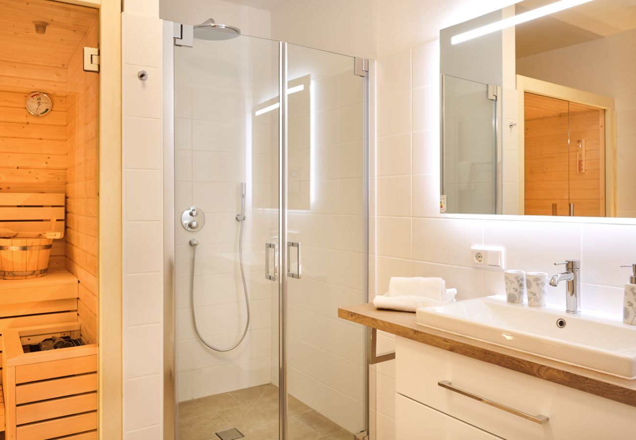 Bathroom with sauna and rain shower in the holiday home flat Alm Lodge A5 in Tauplitz