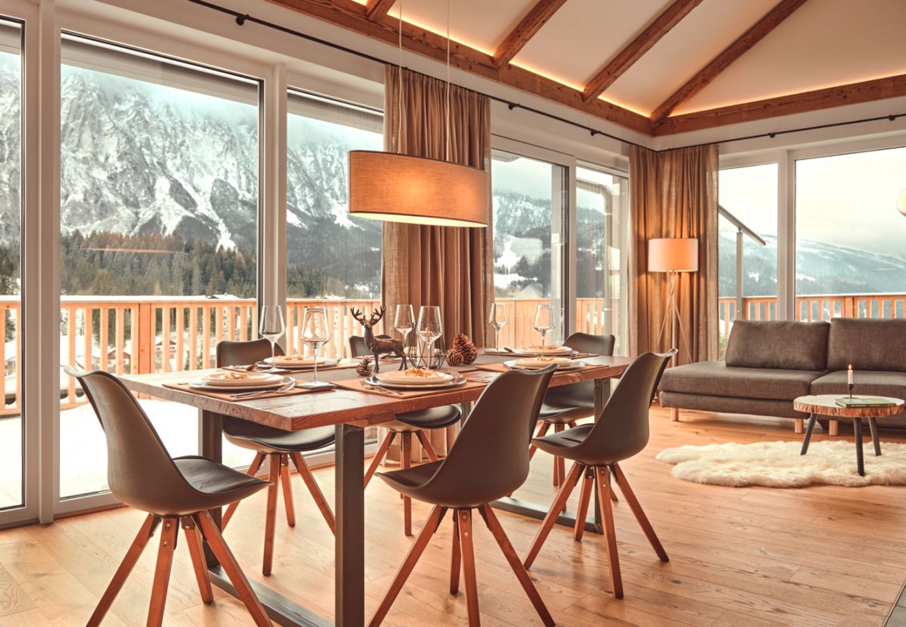 dining table with view over the mountains in the holiday home flat Penthouse Grimming Adler Lodge D7.1 in Tauplitz