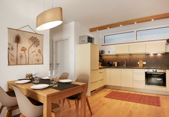 Living room and kitchen in Holiday Home Wasserfall Lodge C2 in Tauplitz