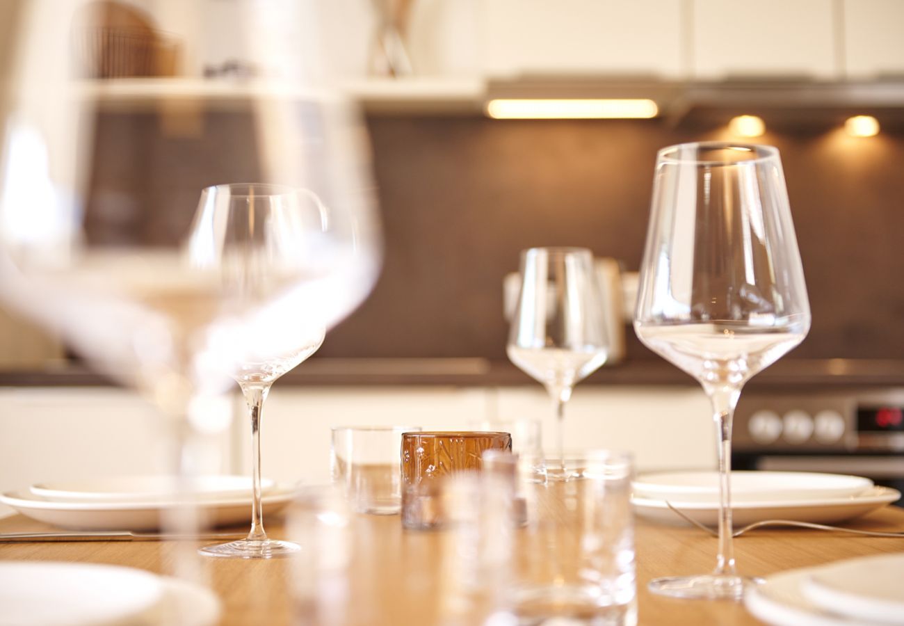 Dining table set with wine glasses in the holiday home flat Adler Lodge D1 in Tauplitz