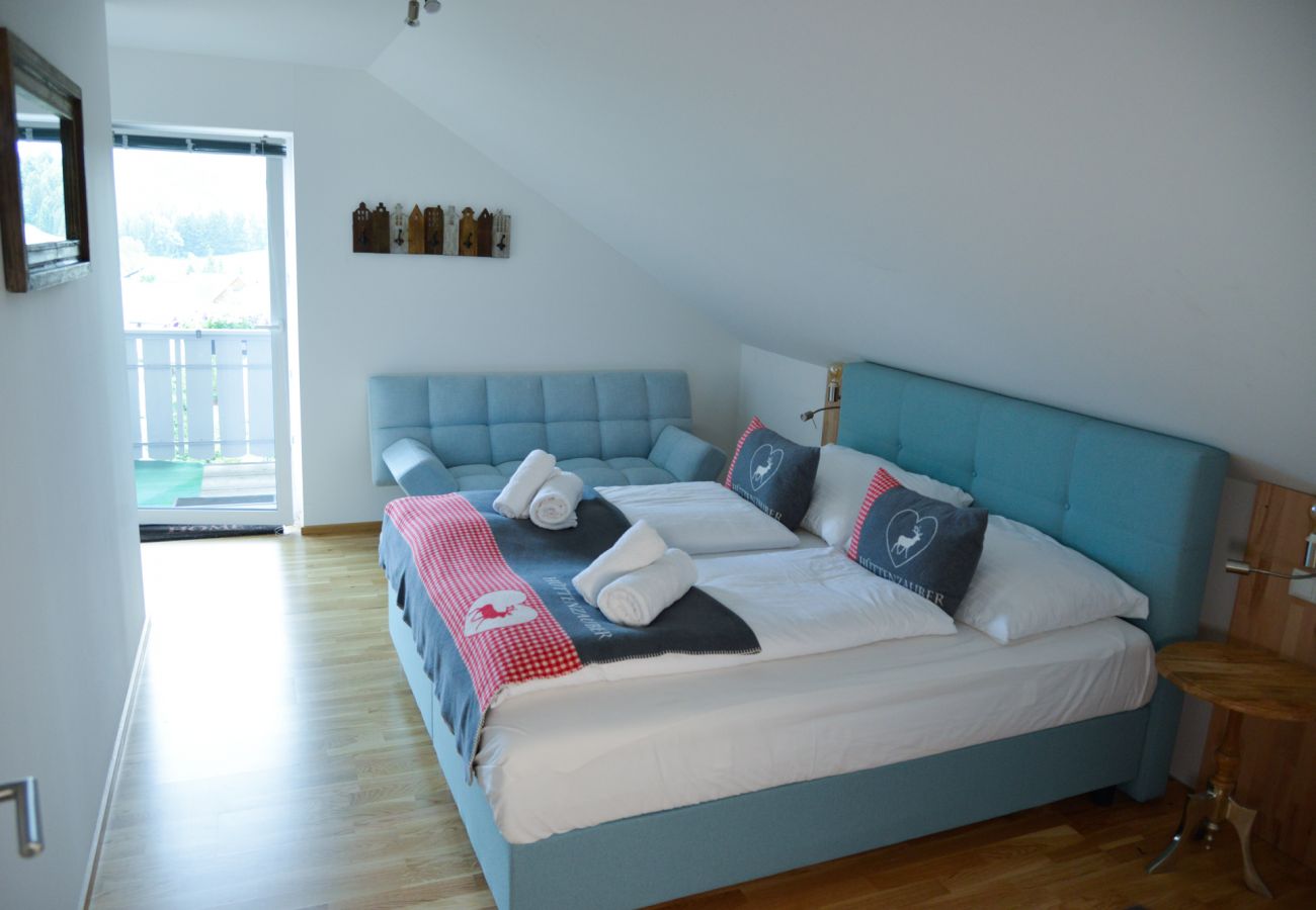 bedroom  with view to the balcony in the holiday home Grimming Lodge Goldrute in Tauplitz