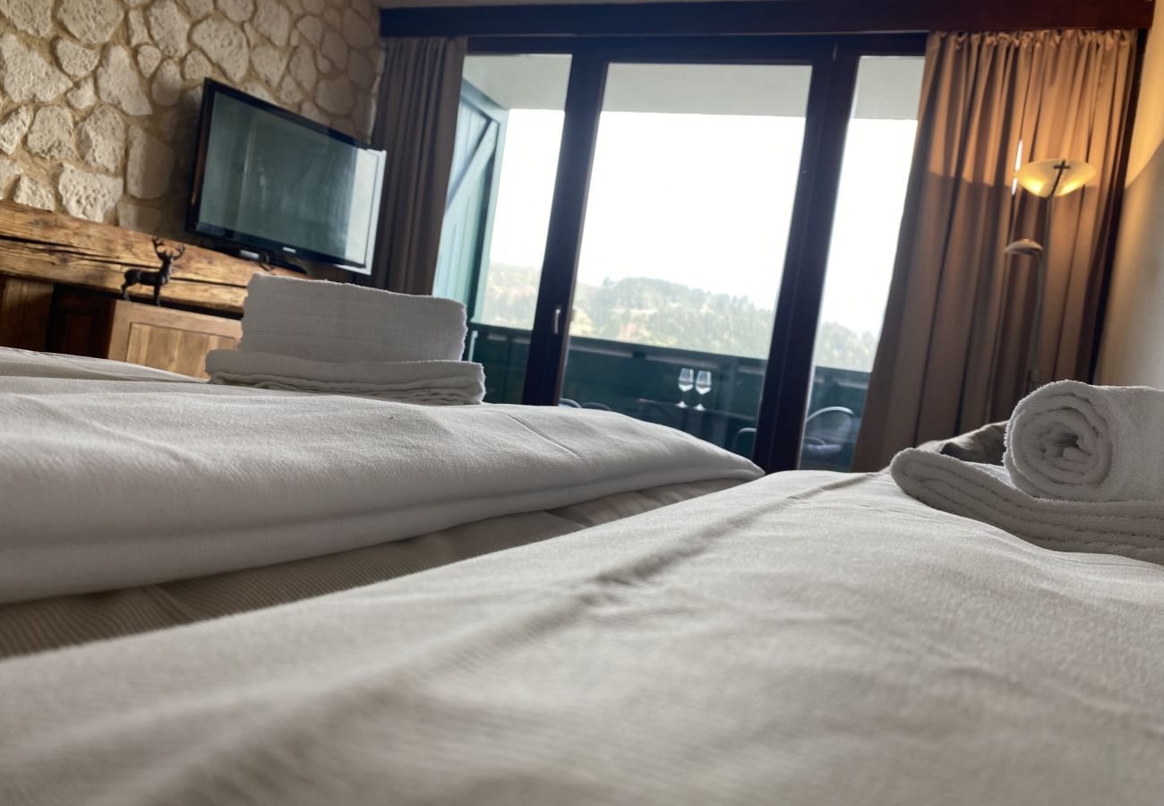 Bedroom with view over the mountains in the holiday home flat Alpine Studio Apartment in the Schladming Dachstein Region