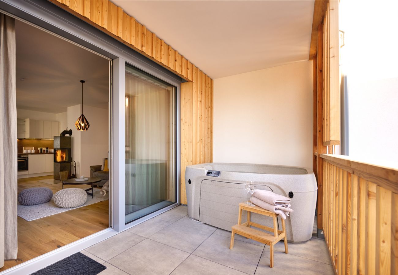 Balkon mit Whirlpool und Sitzgelegenheit in der Ferienwohnung Alm Lodge A5 in Tauplitz